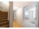 Basement hallway with finished walls and tile flooring leads to bathroom at 503 Hearthstone Rdg, Woodstock, GA 30189