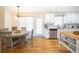 Cozy dining area adjacent to the kitchen with a wooden table and plenty of natural light at 503 Hearthstone Rdg, Woodstock, GA 30189