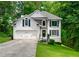 Charming two-story home with stone accents, a well-manicured lawn, and an attached two-car garage at 503 Hearthstone Rdg, Woodstock, GA 30189