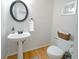 Cozy half bathroom featuring a pedestal sink, modern mirror, and stylish decor at 503 Hearthstone Rdg, Woodstock, GA 30189