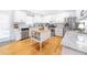 Bright kitchen with white cabinets, an island, granite countertops, and stainless steel appliances at 503 Hearthstone Rdg, Woodstock, GA 30189
