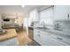 Bright kitchen with white cabinets, stainless steel appliances, and an adjacent dining area at 503 Hearthstone Rdg, Woodstock, GA 30189
