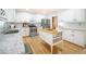 Modern kitchen featuring white cabinets, granite countertops, wooden island, and stainless steel appliances at 503 Hearthstone Rdg, Woodstock, GA 30189
