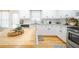 Bright kitchen with white cabinetry, granite countertops, a wooden island, and stainless steel appliances at 503 Hearthstone Rdg, Woodstock, GA 30189