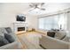 Spacious living room featuring a fireplace, large windows, and stylish gray furniture at 503 Hearthstone Rdg, Woodstock, GA 30189