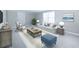 Living room area is staged with a couch, chair and a blue ottoman at 503 Hearthstone Rdg, Woodstock, GA 30189