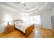 A sunlit bedroom is enhanced by hardwood floors and a large window at 503 Hearthstone Rdg, Woodstock, GA 30189