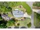 An aerial view shows a home with lush landscaping and a circular driveway at 7660 Dunvegan Close, Sandy Springs, GA 30350