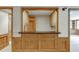 Basement bar area featuring wood cabinetry, a sink, and a pass-through window to another room at 7660 Dunvegan Close, Sandy Springs, GA 30350