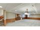 Finished basement with paneled walls, stylish lighting fixtures and carpet flooring at 7660 Dunvegan Close, Sandy Springs, GA 30350