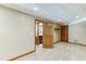 Carpeted basement with wood trim and doorway views of a bathroom and secondary room at 7660 Dunvegan Close, Sandy Springs, GA 30350