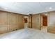 Carpeted basement room featuring wood paneled walls, recessed lighting, and multiple doorways at 7660 Dunvegan Close, Sandy Springs, GA 30350