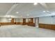 Large basement space with wall panels, recessed lights, and bar area at 7660 Dunvegan Close, Sandy Springs, GA 30350