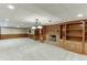 Basement featuring a brick fireplace, built-in shelves, and decorative lighting at 7660 Dunvegan Close, Sandy Springs, GA 30350
