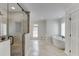 Bright bathroom featuring a standalone tub, shower with glass door, and neutral tile flooring at 7660 Dunvegan Close, Sandy Springs, GA 30350