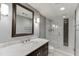 Modern bathroom featuring a marble vanity, large mirror, and glass-enclosed shower with white tiling at 7660 Dunvegan Close, Sandy Springs, GA 30350