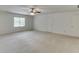 Large room with ceiling fan and natural light from the window and neutral walls at 7660 Dunvegan Close, Sandy Springs, GA 30350