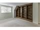Carpeted bedroom with large built-in shelving and natural light from a window at 7660 Dunvegan Close, Sandy Springs, GA 30350