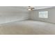 Large bedroom with a ceiling fan and a window providing natural light at 7660 Dunvegan Close, Sandy Springs, GA 30350