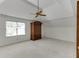 Bedroom with high ceilings, neutral carpet, lots of natural light, and an antique armoire at 7660 Dunvegan Close, Sandy Springs, GA 30350