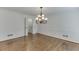 Elegant dining room with hardwood floors, decorative wall trim, and chandelier at 7660 Dunvegan Close, Sandy Springs, GA 30350
