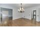 Dining room with hardwood floors, classic trim, and chandelier lighting at 7660 Dunvegan Close, Sandy Springs, GA 30350