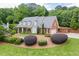 Charming home with manicured lawn, lush landscaping, and classic architectural details at 7660 Dunvegan Close, Sandy Springs, GA 30350