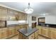 Spacious kitchen featuring an island, custom cabinets, stainless steel appliances, and hardwood floors at 7660 Dunvegan Close, Sandy Springs, GA 30350