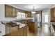 Well-lit kitchen with custom wood cabinets, stainless steel appliances, and hardwood floors at 7660 Dunvegan Close, Sandy Springs, GA 30350
