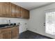 Laundry room featuring custom cabinets and a sink at 7660 Dunvegan Close, Sandy Springs, GA 30350