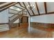 Bright living room with hardwood floors, a vaulted ceiling with wood beams, and staircase to the second floor at 7660 Dunvegan Close, Sandy Springs, GA 30350