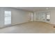 Large living room features neutral carpet, white trim and French doors to the exterior at 7660 Dunvegan Close, Sandy Springs, GA 30350
