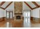 Spacious living room featuring hardwood floors, vaulted ceilings, and a stone fireplace at 7660 Dunvegan Close, Sandy Springs, GA 30350