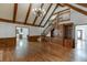 Spacious living room featuring hardwood floors, a vaulted ceiling with wood beams, and built-in cabinets at 7660 Dunvegan Close, Sandy Springs, GA 30350
