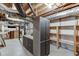 Unfinished basement with exposed ductwork, shelving, and storage cabinets at 7660 Dunvegan Close, Sandy Springs, GA 30350
