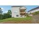 Backyard view of home featuring a patio, green lawn and gray vinyl siding at 2646 Neighborhood S Walk, Villa Rica, GA 30180