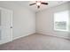 Neutral bedroom featuring plush carpet, a ceiling fan, and a bright window at 2646 Neighborhood S Walk, Villa Rica, GA 30180