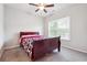Bedroom featuring neutral carpet, ceiling fan and a bed with red accents at 2646 Neighborhood S Walk, Villa Rica, GA 30180