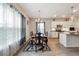 Dining area with a view of the kitchen featuring modern lighting, decor, and wood-look flooring at 2646 Neighborhood S Walk, Villa Rica, GA 30180