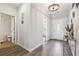 Bright foyer with chandelier, gray walls, wood-look floors, decorative accents, and a view of rooms through doorways at 2646 Neighborhood S Walk, Villa Rica, GA 30180