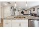 Kitchen island with granite counters, stainless steel appliances, and a view of the Gathering room and fireplace at 2646 Neighborhood S Walk, Villa Rica, GA 30180