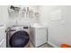 Cozy laundry room with washer, dryer, shelving, and ample storage at 2646 Neighborhood S Walk, Villa Rica, GA 30180