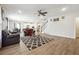 Spacious living room features wood-look floors, contemporary decor, and an open view of the kitchen and dining area at 2646 Neighborhood S Walk, Villa Rica, GA 30180