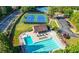 Aerial view of community pool and tennis courts; lounge chairs and manicured lawns at 3330 Arborwoods Dr, Alpharetta, GA 30022
