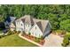 Beautiful two-story home with a well-maintained lawn, driveway, and classic architectural design at 3330 Arborwoods Dr, Alpharetta, GA 30022