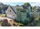 Home aerial view featuring a garden, a rear-facing garage, a patio, and an enclosed back porch at 3330 Arborwoods Dr, Alpharetta, GA 30022