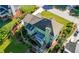 Aerial view of the backyard featuring a lush garden, deck, screened porch and well maintained lawn at 3330 Arborwoods Dr, Alpharetta, GA 30022