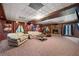 Basement movie room featuring projector and screen with leather furniture at 3330 Arborwoods Dr, Alpharetta, GA 30022