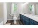 Bathroom with blue vanity, quartz countertops, and shower with curtain at 3330 Arborwoods Dr, Alpharetta, GA 30022