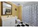 Bathroom features yellow walls, checkered floors and shower with curtain at 3330 Arborwoods Dr, Alpharetta, GA 30022